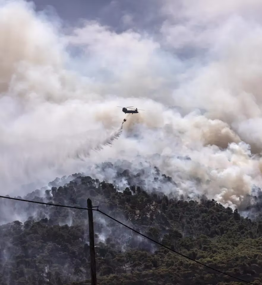 Firefighting aircraft dropping water on wildfire